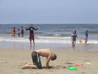 IMG_1806 Christian Hollingsworth in the background with kite while Aiden digs in the sand